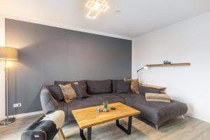 a living room with a couch and a table at Ferienhaus Diemelblick in Heringhausen