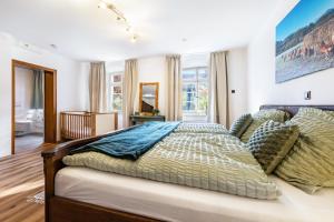 a bedroom with a large bed with pillows at Kempers Auszeit in Plettenberg