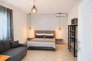 a bedroom with a bed and a couch at Studios River - Potos Escape with Pool and Views in Potos +32 photos