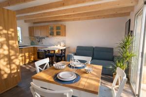 a kitchen and living room with a table and chairs at Entre Nature et Océan in Commequiers