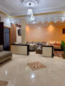 a large living room with couches and a chandelier at Dar dyafa in Meknès