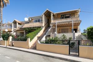 a house on the side of a street at Heads 2 Holiday Homes Apartment in Villamartin