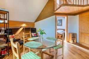 a dining room with a glass table and chairs at Hof Wegwarte in Weilheim