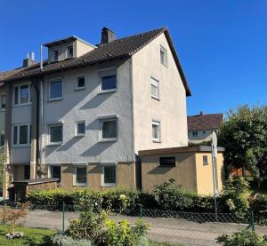 a large apartment building next to a fence at Joos Boardinghouse in Radolfzell am Bodensee
