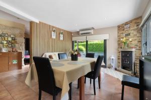 a dining room with a table and chairs and a bedroom at Quinta Da Cevidade in Melgaço