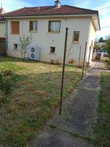 a pole in the grass in front of a house at Maison entière Garage et parking in Montluçon