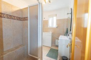 a bathroom with a shower and a toilet and a sink at Casa La Paz in Torrox +11 photos