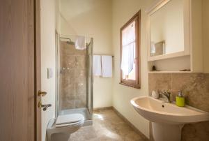 a bathroom with a sink and a toilet and a shower at Chalet Rosmarino in Trequanda +23 photos