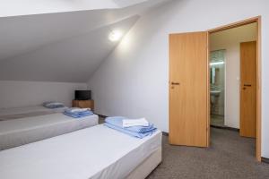 a bedroom with two beds and a door to a bathroom at Julia rooms in Sofia