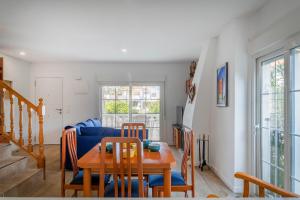 a living room with a table and a blue couch at Bungalow 213 in Alicante