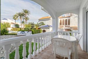 a white balcony with a table and chairs at Bungalow 213 in Alicante