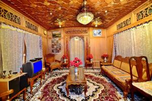 a living room with a couch and a tv at Golden Crest DALLAKE in Srinagar