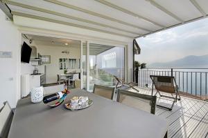 a room with a table and chairs on a balcony at Residence La Mignon Terrazza in Torri del Benaco