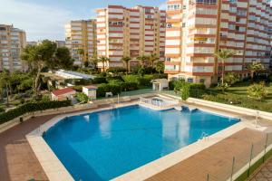 an overhead view of a large blue swimming pool with tall buildings at Apartamento Sol Playa Torrox A55 in Torrox Costa