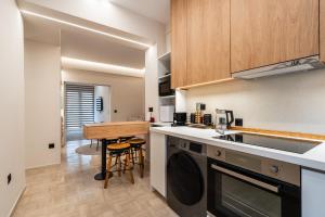 a kitchen with a table and a counter top at The Apex Boutique Apartment B2 in Athens +12 photos