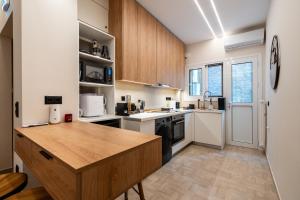 a kitchen with wooden cabinets and a wooden counter top at The Apex Boutique Apartment B2 in Athens