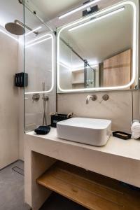 a bathroom with a sink and a mirror at The Apex Boutique Apartment B2 in Athens