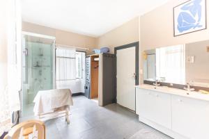 a bathroom with a sink and a mirror at La Serre in Laborde