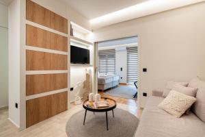 a living room with a couch and a table at The Apex Boutique Apartment B2 in Athens