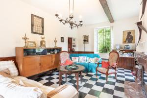 a living room with a couch and chairs at La Serre in Laborde