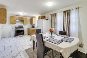 a kitchen and dining room with a table and chairs at Walk to Shops & Eats! Attleboro Basecamp in Attleboro