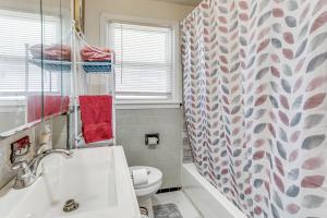 a bathroom with a sink and a toilet and a shower curtain at Walk to Shops & Eats! Attleboro Basecamp in Attleboro +16 photos