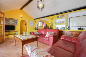 a living room with a red couch and a table at Villa Casa Concha in Teguise