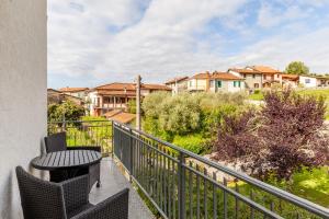 a balcony with a table and chairs and houses at Villa La Lanterna Bianca a Bagnone in Bagnone