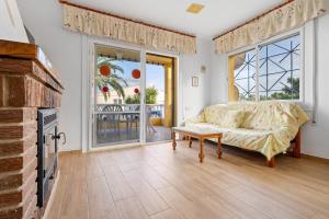 a living room with a couch and a fireplace at Villa Amador in L'Ampolla +23 photos