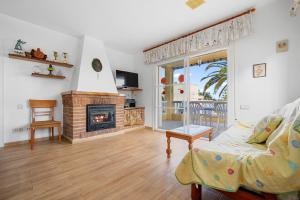 a living room with a fireplace and a couch at Villa Amador in L'Ampolla