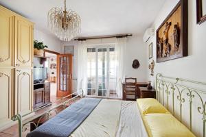 a bedroom with a bed and a chandelier at Ca Olivella in Casarza Ligure