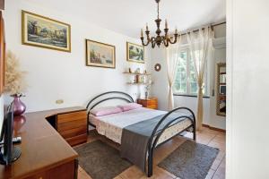 a bedroom with a bed and a desk at Ca Olivella in Casarza Ligure +21 photos