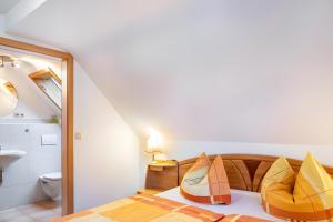 a bedroom with a bed with orange and yellow pillows at Fewo Edith in Gersfeld