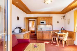 a kitchen with a couch and a table in a room at Alpenblick Tilly - Fewo Barmsee 2 in Krün