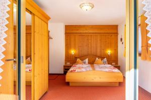 a bedroom with two beds and a door open at Alpenblick Tilly - Fewo Barmsee 2 in Krün