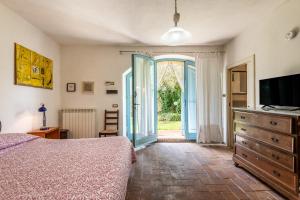 a bedroom with a bed and a tv and a window at Nido blu loft in Siena