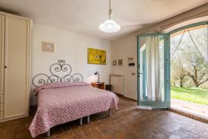 a bedroom with a bed and a large window at Nido blu loft in Siena