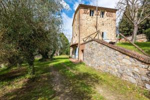 an external view of a stone building with a stone wall at Nido blu loft in Siena