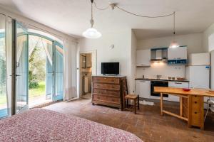 a bedroom with a bed and a kitchen with a table at Nido blu loft in Siena