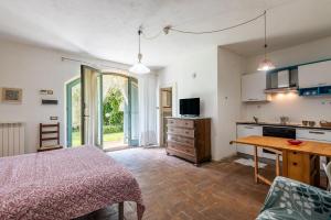 a bedroom with a bed and a table and a kitchen at Nido blu loft in Siena +18 photos