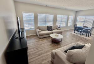 a living room with a couch and a table at The HoneyBee at Coventry Rows in Omaha