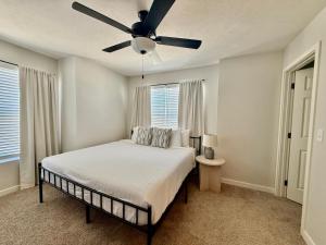 a bedroom with a bed with a ceiling fan at The HoneyBee at Coventry Rows in Omaha