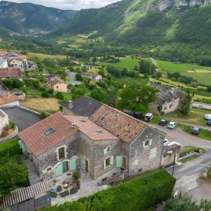 an aerial view of a house with mountains in the background at Gite Sublime Spa, Piscine Indoor in Mostuéjouls