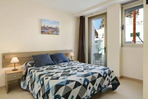 a bedroom with a bed and a window at Albamar 1a in Puerto de Mogán