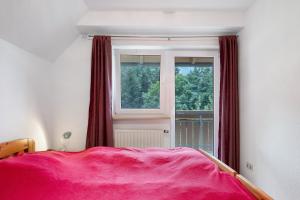 a bedroom with a pink bed and a window at Grundhof Christian Faller in Rohr