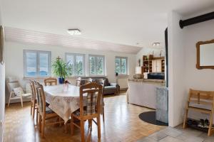 a dining room and living room with a table and chairs at Grundhof Christian Faller in Rohr