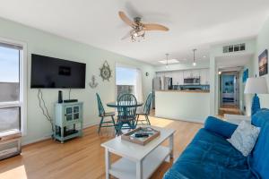 a living room with a blue couch and a table at Delightful Diversion in Duck