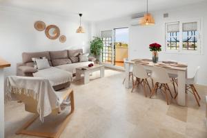 a living room with a couch and a table at Baviera Homes Sunset and Golf in Caleta De Velez
