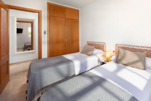 two beds sitting next to each other in a bedroom at Baviera Homes Sunset and Golf in Caleta De Velez +16 photos