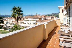 a balcony with a view of a city at Baviera Homes Sunset and Golf in Caleta De Velez